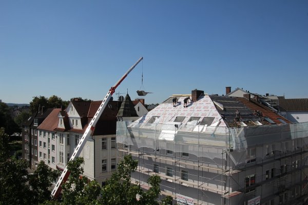 crane moving roofing tiles